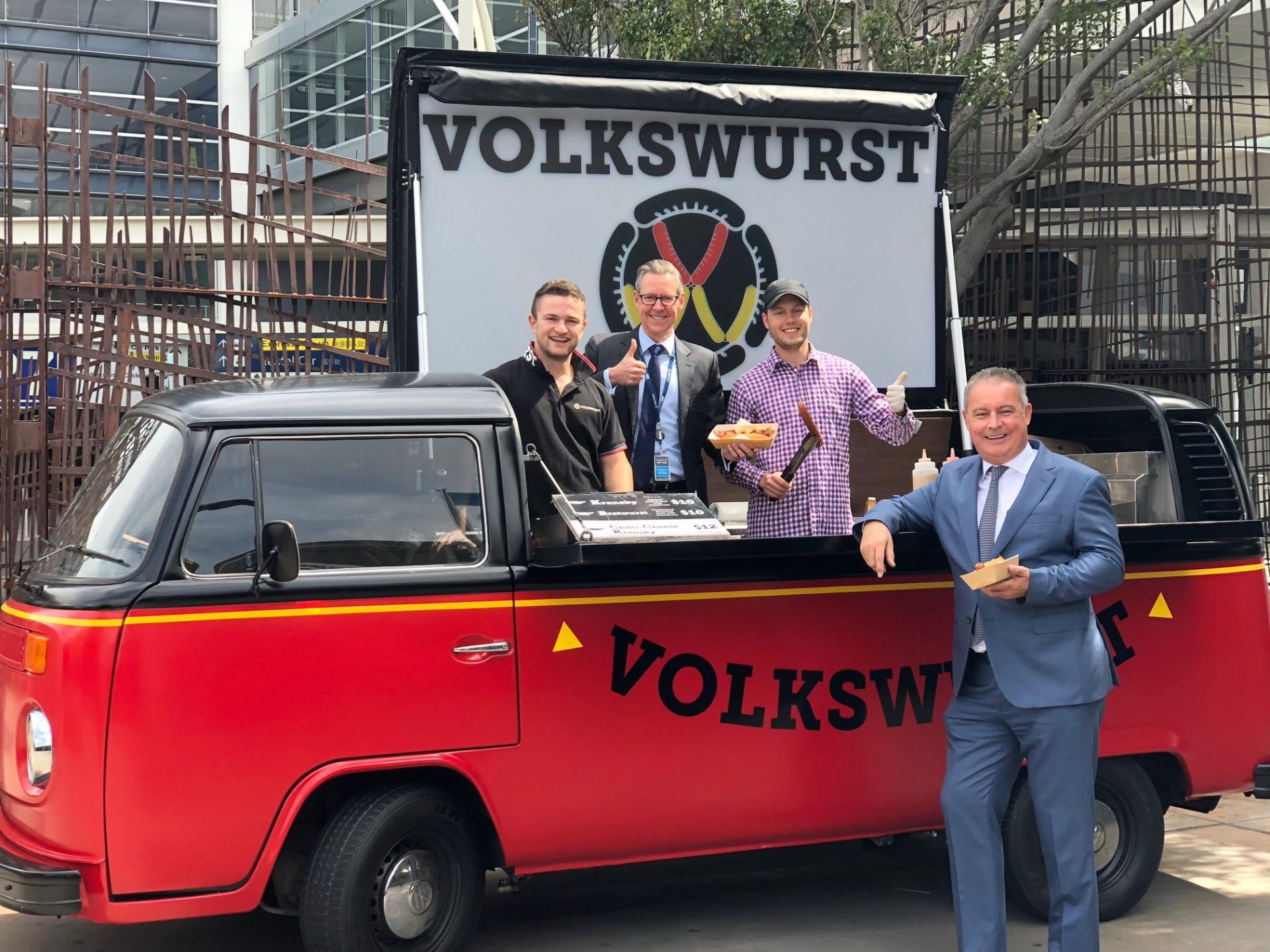 Volkswurst team serving German street food from the vintage VW Kombi